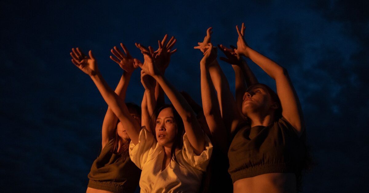 Taniec - A Low Angle Shot of Women Dancing while Raising their Hands