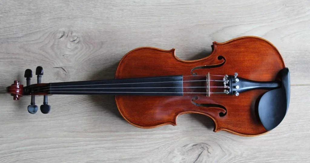 Altówka - brown violin on white textile