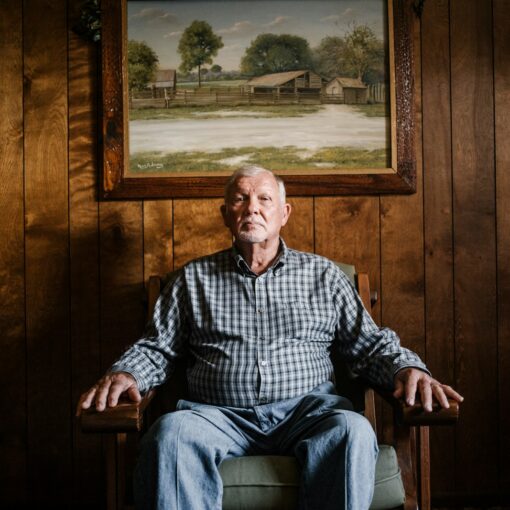 Mieszko man sitting on armchair beside photo frame